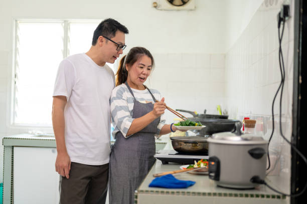 istock An Asian couple preparing healthy meal in kitchen 1323166360