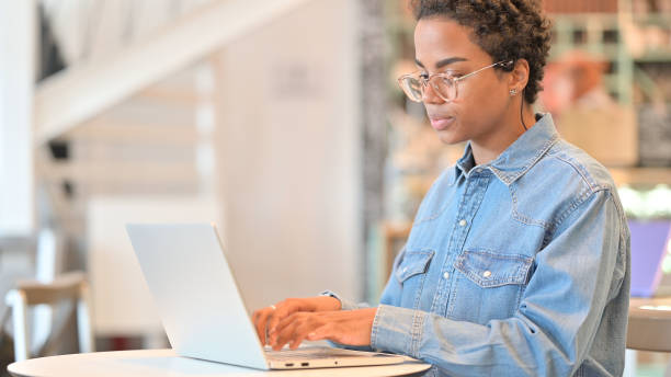 istock African Woman Working on Laptop at Cafe 1323166416