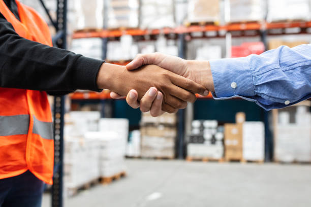 istock Warehouse worker shaking hands with the foreman 1323167223