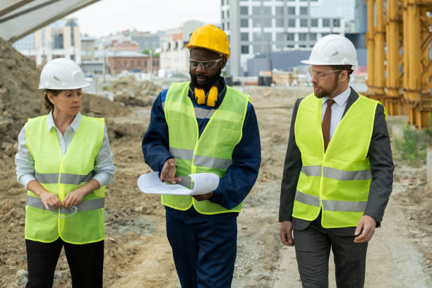 istock Young African builder explaining sketch of construction to colleagues 1323168967