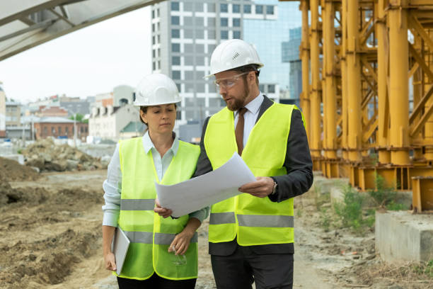 istock Young contemporary builders discussing sketch 1323168985