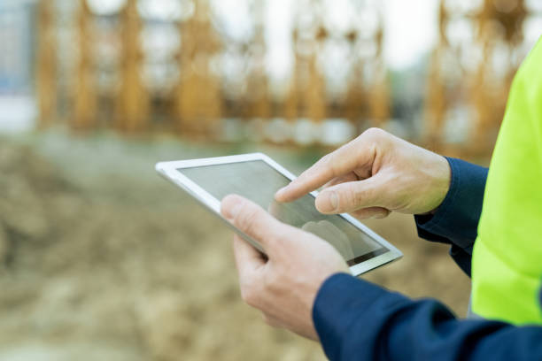 istock Hand of engineer pointing at screen of tablet 1323169040