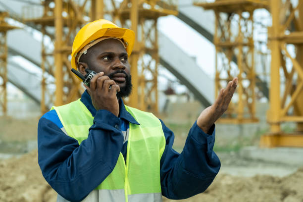 istock African foreman in workwear speaking on walkie-talkie 1323169047