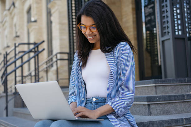 istock Business woman using laptop computer, searching information, communication online. Smiling freelancer typing on laptop, working project outdoors. Successful business concept 1323169894