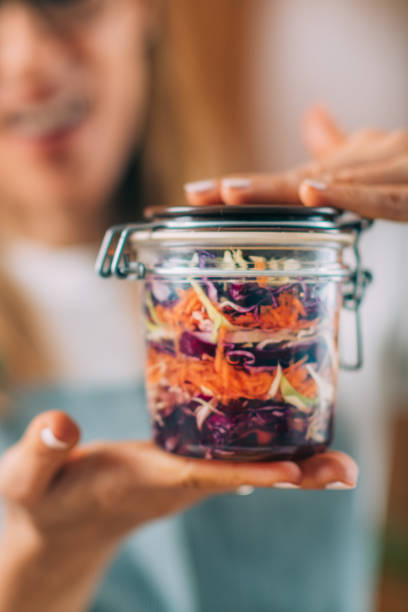 istock Woman Holding a Jar with Fermented Vegetables. 1323170092