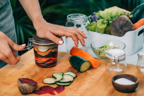 istock Woman Holding a Jar with Fermented Vegetables. 1323171005