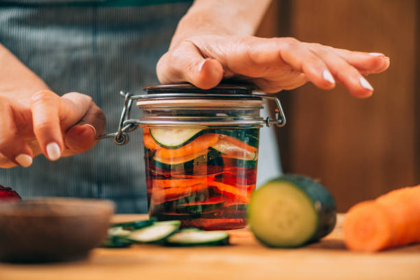 istock Woman Holding a Jar with Fermented Vegetables. 1323171220