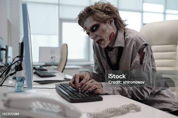 Ugly Man With Zombie Makeup Working With Computer Stock Photo - Download Image Now - Zombie, Office, Computer Monitor