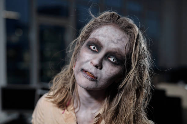 Zombie female standing in front of camera in dark room or office