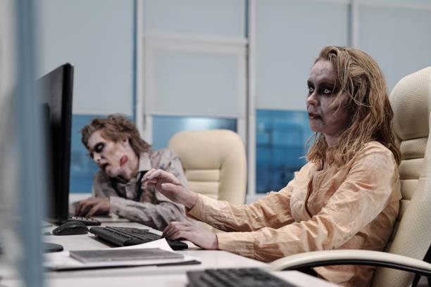 istock Ugly zombie female sitting in front of computer 1323172424