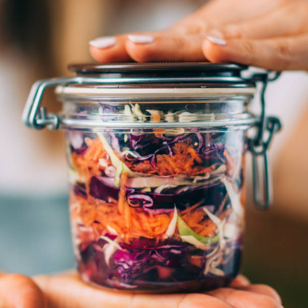 istock Woman Holding a Jar with Fermented Vegetables. 1323172545
