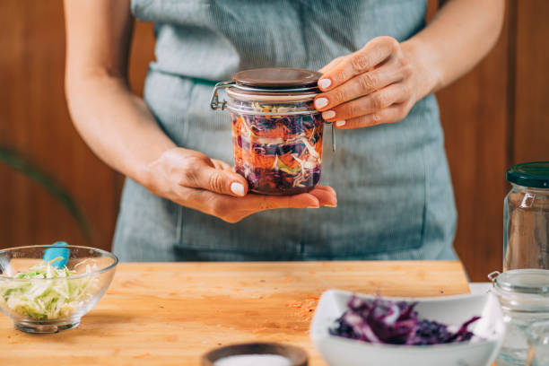 istock Woman Holding a Jar with Fermented Vegetables. 1323172714