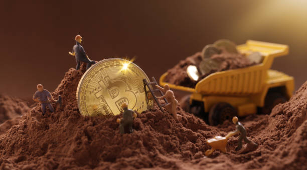 Miner digging ground to uncover big Gold bitcoin. Cryptocurrency Mining concept Kiev, Ukraine - June 10, 2021: Miner digging ground to uncover big Gold bitcoin. Cryptocurrency Mining concept cryptocurrency mining photos stock pictures, royalty-free photos & images