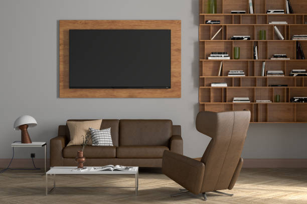 istock TV screen mock up on the white wall in modern living room. 1323178355