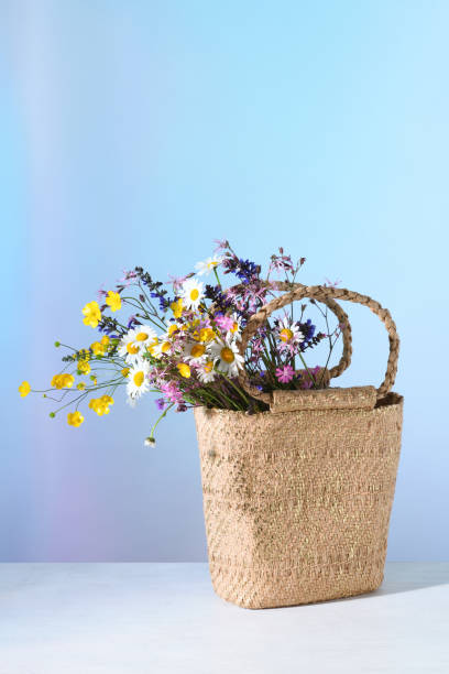 istock Straw bag with flowers 1323178733