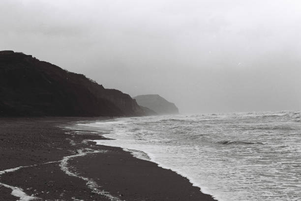 Black and White 35mm of a gloomy day of the Jurassic Coast in Dorset, from Lyme Regis looking towards Charmouth and beyond