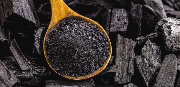 istock wooden spoon with coal dust on pieces of coal 1323180643