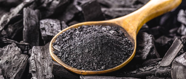 istock wooden spoon with coal dust on pieces of coal 1323180665