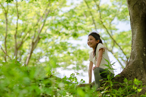 Girl smile sit in the shade of a tree