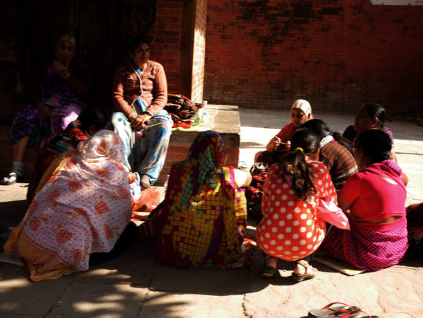 Life and lifestyle of nepali women people sitting join group talk on floor in morning at outdoor in thamel old town at Basantapur Katmandu durbar square area on December 2, 2017 in Kathmandu, NepalLif