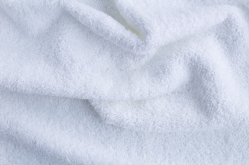 Textile  background. White terry towel. Top view. Copy space. Closeup.