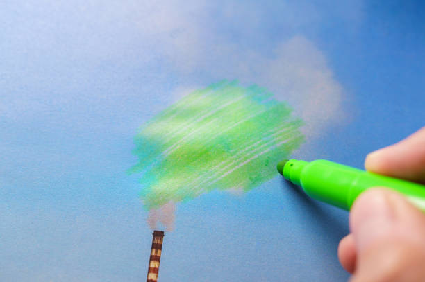 Man painting green pollution from a chimney stock photo