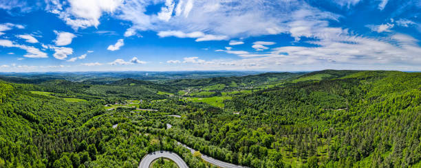 istock Panoramic Drone View Over Lesko and Sanok County, Forest and Curvy Serpentine Road 1323188567