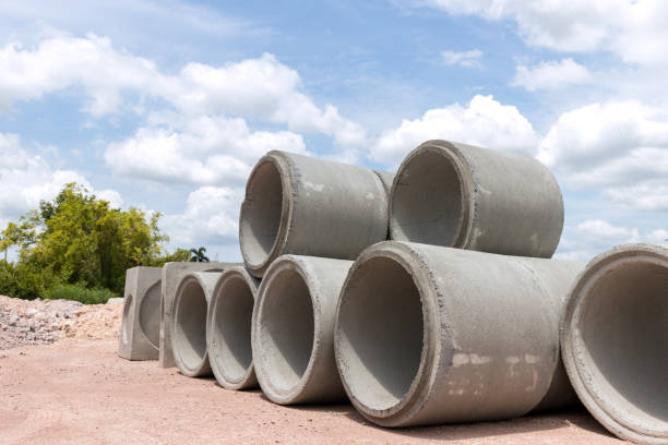 istock Concrete Drainage Pipe on a Construction Site.  Concrete drainage pipes stacked for construction. Concrete drainage tube on construction site near high way road 1323189441
