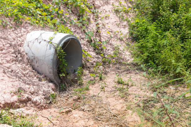 istock Concrete circular run-off pipe discharging water. sewage pipe polluting the river. Sewage or domestic wastewater or municipal wastewater that is product by community of people. 1323189491