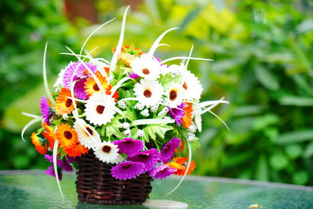 Close-up beautiful Flowers in  vase on table in garden