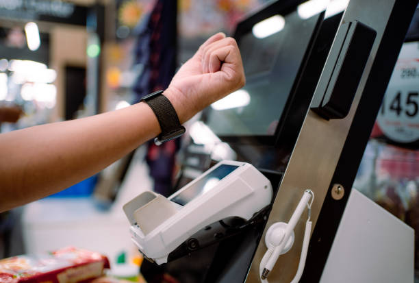 istock Close up hands Asian Customer paying bill using a smartwatch. 1323191835