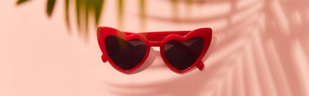 istock Red heart shaped sunglasses on pink background 1323191963