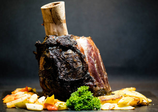 Schmorbraten Beef Hammer - the knuckle of beef with vegetables shin stock pictures, royalty-free photos & images
