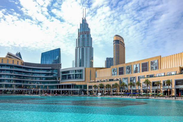 Dubai, modern architectures Dubai, United Arab Emirates - May 16, 2018: Towers and the Dubai Mall seen from the lake of Emaar square dubai mall stock pictures, royalty-free photos & images