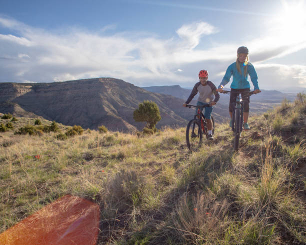 Mountain bikers follow trail along mountain ridge