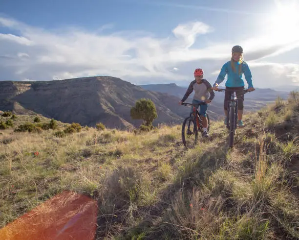 Photo of Mountain bikers follow trail along mountain ridge