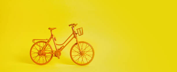 istock The vintage yellow bicycle parking against yellow wall. 1323201633