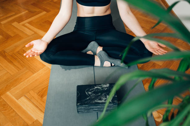 istock Anonymous Sportswoman Meditating on the Floor after a Workout 1323202117