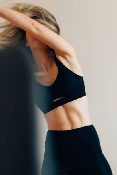 istock Beautiful Female Athlete Standing and Doing Warm Up Exercises 1323202176