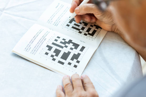 istock Senior Woman Doing Crossword Puzzle 1323204130