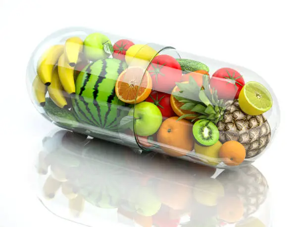 Photo of Vitamin pill capsule with fruits and vegetables. Nutrition supplemet and health eating concept.