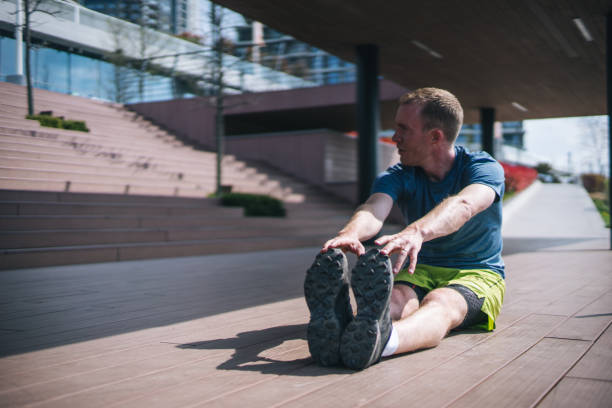 istock Young man stretches before heading out on morning run 1323205846