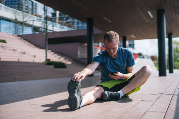 istock Young man stretches before heading out on morning run 1323205894
