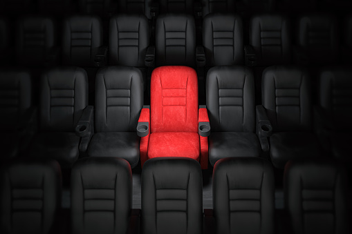 One red empty seat among others black seats in cinema hall. 3d illustration