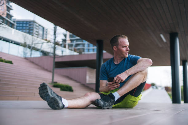 istock Young man stretches before heading out on morning run 1323205988