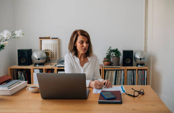 istock Successful Mature Businesswoman Working from Home, Using a Laptop 1323206633