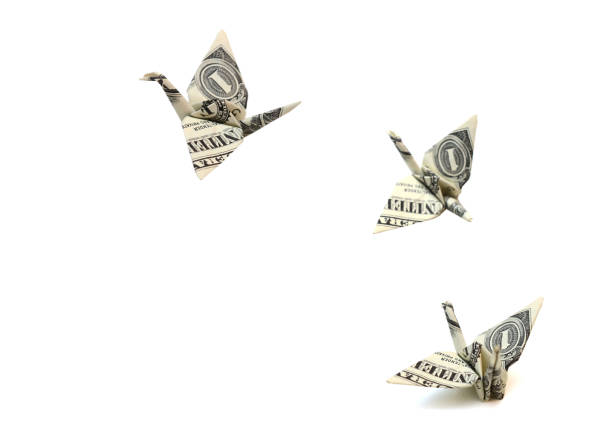 istock Flying origami dollar bird on white 1323207200