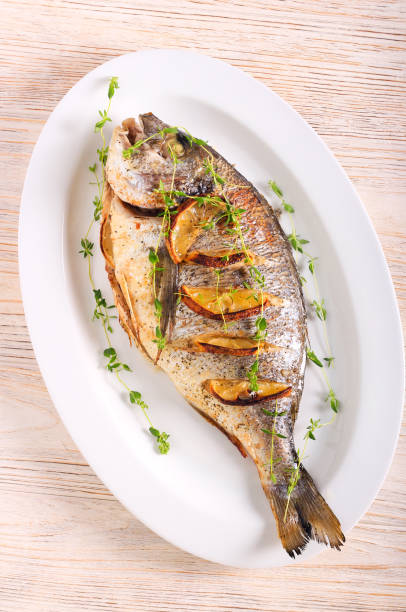 istock Thyme and lemon baked sea bream fish 1323208084