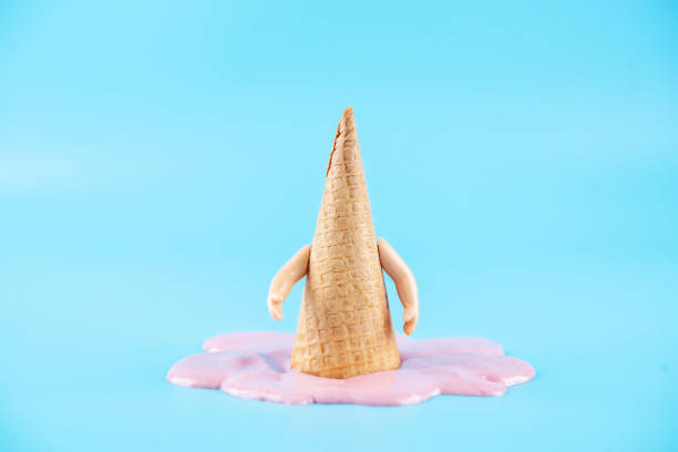 istock Inverted waffle cone with berry ice cream on a blue background 1323208331