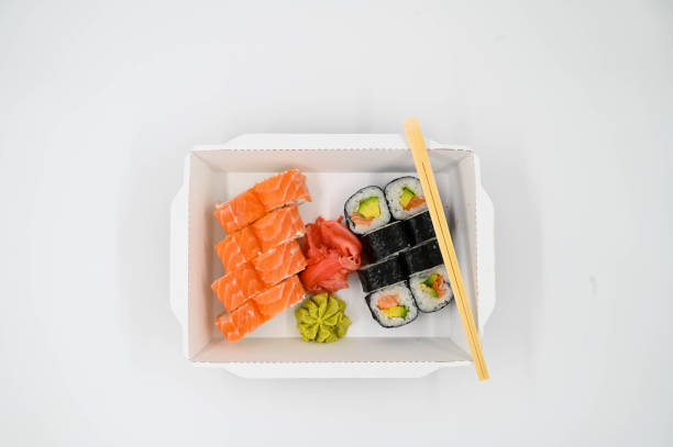 istock Sushi sets with red ginger and wasabi in a takeaway box on an isolated white background 1323208342